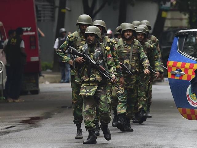 Bangladeshi soldiers patrol a street during a rescue operation as gunmen take position in a restaurant in Dhaka’s high-security diplomatic district.(AFP) Bangladeshi soldiers patrol a street during a rescue operation as gunmen take position in a restaurant in Dhaka’s high-security diplomatic district.(AFP)