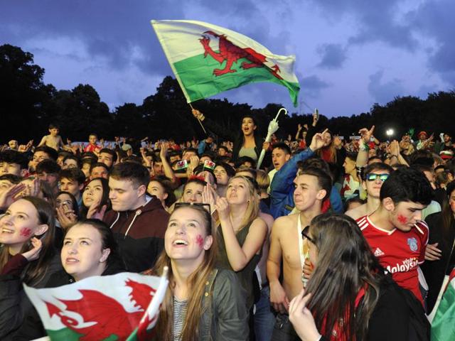Welsh fans cheer the third goal scored by Wales during the team’s match against Belgium, being shown on a big screen in the Fanzone, Coopers Field, Cardiff, Wales. (Reuters Photo) 