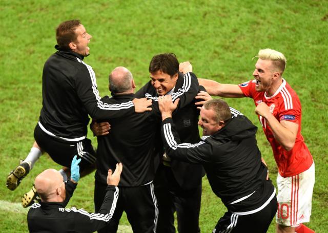 Wales' midfielder Aaron Ramsey (right) celebrates with Wales' coach Chris Coleman (centre) and team staff at the end of the Euro 2016 quarterfinal football match against Belgium. (AFP Photo) Wales' midfielder Aaron Ramsey (right) celebrates with Wales' coach Chris Coleman (centre) and team staff at the end of the Euro 2016 quarterfinal football match against Belgium. (AFP Photo)