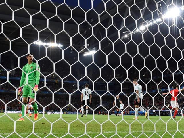 Wales' forward Gareth Bale (right) celebrates after a goal next to Belgium's goalkeeper Thibaut Courtois (left). (AFP Photo) 