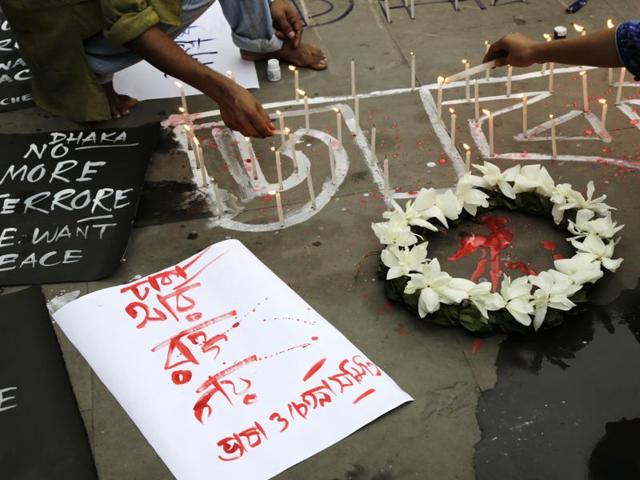 Indian activists participate in a candle light vigil protesting the Bangladesh restaurant attack. (AP Photo) Indian activists participate in a candle light vigil protesting the Bangladesh restaurant attack. (AP Photo)