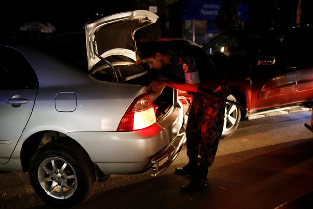 Security personnel check vehicles after gunmen stormed the Holey Artisan restaurant and took hostages. (REUTERS) Security personnel check vehicles after gunmen stormed the Holey Artisan restaurant and took hostages. (REUTERS)
