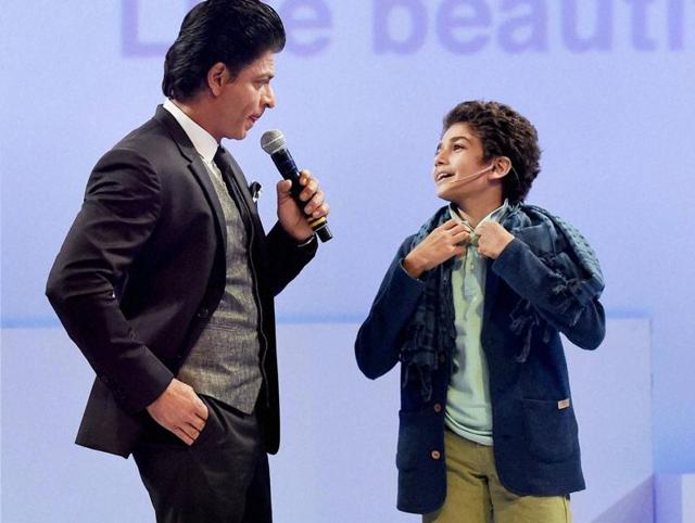 Shah Rukh Khan interacts with a fan during a promotional event in Mumbai. (PTI)