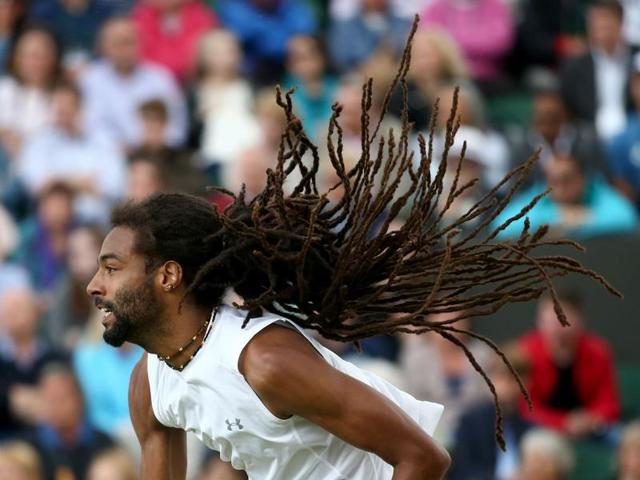 Germany's Dustin Brown serves to Australia's Nick Kyrgios during their men's singles second round match. (AFP Photo) 