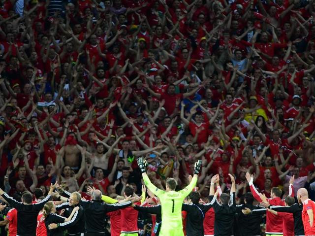 Wales' players celebrate with supporters after the Euro 2016 quarterfinal football match against Belgium at the Pierre-Mauroy stadium in Villeneuve-d'Ascq. (AFP Photo) 