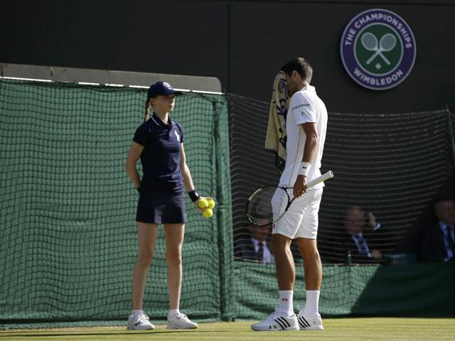 Djokovic towels off between points. (REUTERS) Djokovic towels off between points. (REUTERS)