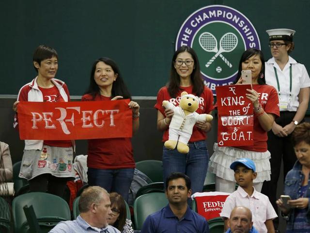 Roger Federer fans hold signs during his match against Great Britain's Daniel Evans. (Reuters Photo) 