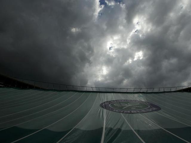 Court covers after rain stopped play during Wimbledon Championships in London.  (Reuters Photo) 