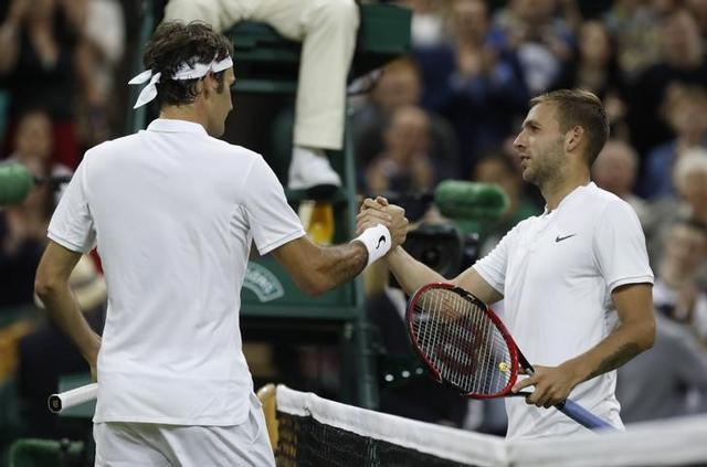 Switzerland's Roger Federer (left) shakes hands with Great Britain's Daniel Evans. (Reuters Photo) Switzerland's Roger Federer (left) shakes hands with Great Britain's Daniel Evans. (Reuters Photo)