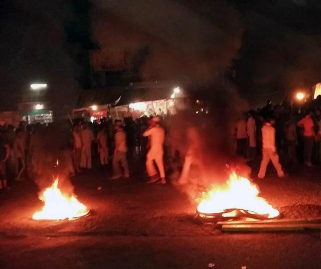 In the violence that ensued after the alleged desecration, people burnt tyres to block the national highway at Malerkotla. (HT Photo) In the violence that ensued after the alleged desecration, people burnt tyres to block the national highway at Malerkotla. (HT Photo)