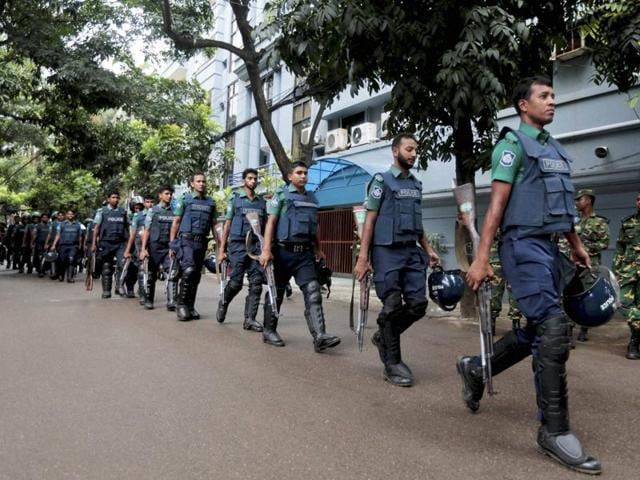 Bangladeshi policemen patrol the area around the site of an attack in Dhaka. (AP) Bangladeshi policemen patrol the area around the site of an attack in Dhaka. (AP)