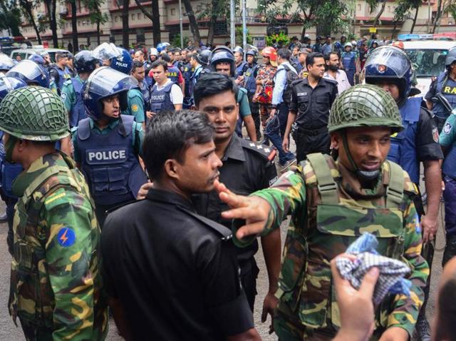 Bangladeshi police and military gather in an intersection near an upscale restaurant after a bloody siege ended in Dhaka on Saturday.(AFP)