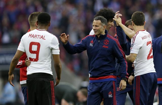 Manchester United’s former assistant manager Ryan Giggs celebrates with player Anthony Martial after winning the English FA Cup final against Crystal Palace at Wembley Stadium, London. (AP Photo) Manchester United’s former assistant manager Ryan Giggs celebrates with player Anthony Martial after winning the English FA Cup final against Crystal Palace at Wembley Stadium, London. (AP Photo)