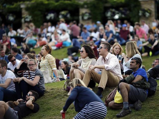 Spectators watch the action on a giant screen outside Henman Hill. (AP)