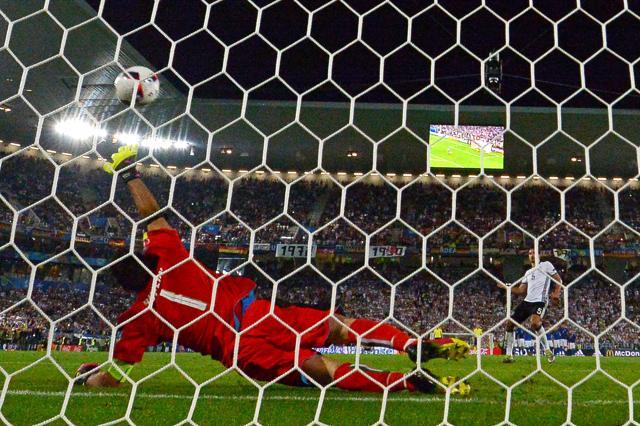 Italy's goalkeeper Gianluigi Buffon misses the ball as Germany's defender Mats Hummels scores during a spot-kick in a penalty shootout in the Euro 2016 quarterfinal football match against Germany. (AFP Photo) Italy's goalkeeper Gianluigi Buffon misses the ball as Germany's defender Mats Hummels scores during a spot-kick in a penalty shootout in the Euro 2016 quarterfinal football match against Germany. (AFP Photo)