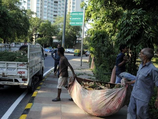 NDMC workers collect garbage from a street in New Delhi. (HT File Photo) NDMC workers collect garbage from a street in New Delhi. (HT File Photo)