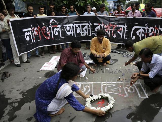 Indian activists participate in a candle light vigil protesting the Bangladesh restaurant attack, in Kolkata on Saturday. (AP)