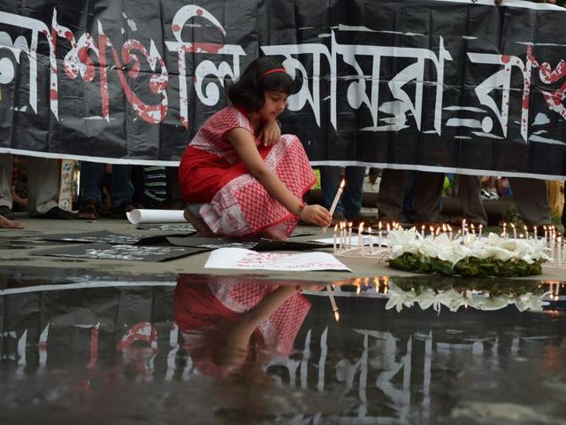 A girl lights candles at a protest against the Dhaka terror attack, in Kolkata on Saturday. (AFP)