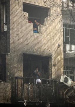Iraqi men stand inside a damaged building at the site of a suicide car bombing claimed by the Islamic State group on July 3 in Baghdad's central Karrada district. (AFP Photo) Iraqi men stand inside a damaged building at the site of a suicide car bombing claimed by the Islamic State group on July 3 in Baghdad's central Karrada district. (AFP Photo)