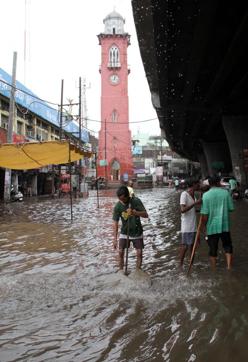 Workers opening a manhole to let rainwater seep in near the clock tower in Ludhiana on Saturday. (JS Grewal /HT) Workers opening a manhole to let rainwater seep in near the clock tower in Ludhiana on Saturday. (JS Grewal /HT)