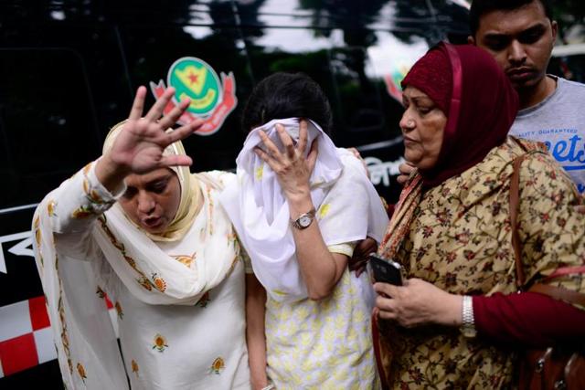 People react near the Holey Artisan restaurant after Islamist militants attacked the upscale cafe in Dhaka, Bangladesh, July 2, 2016. (Reuters Photo) People react near the Holey Artisan restaurant after Islamist militants attacked the upscale cafe in Dhaka, Bangladesh, July 2, 2016. (Reuters Photo)