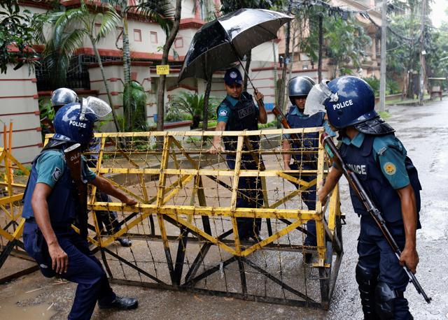 Policemen move a barricade on the road leading to the Holey Artisan Bakery and the O'Kitchen Restaurant after gunmen attacked, in Dhaka, Bangladesh. (Reuters) Policemen move a barricade on the road leading to the Holey Artisan Bakery and the O'Kitchen Restaurant after gunmen attacked, in Dhaka, Bangladesh. (Reuters)