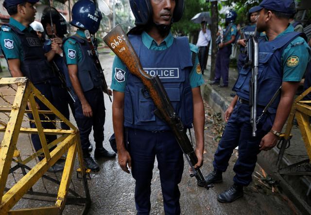 Policemen stand guard along a road leading to the Holey Artisan Bakery and the O'Kitchen Restaurant after gunmen attacked, in Dhaka, Bangladesh. (Reuters) Policemen stand guard along a road leading to the Holey Artisan Bakery and the O'Kitchen Restaurant after gunmen attacked, in Dhaka, Bangladesh. (Reuters)