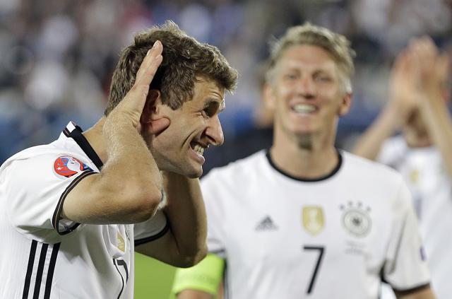 Germany's Thomas Mueller and Germany's Bastian Schweinsteiger (right) celebrate after Germany won the penalty shootout of the Euro 2016 quarterfinal match against Italy. (AP Photo)