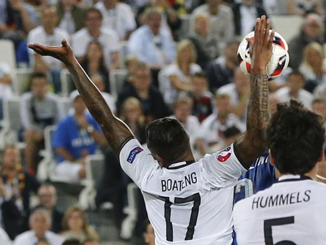 Germany's Jerome Boateng touches the ball with his right hand during the Euro 2016 quarterfinal football match, awarding Italy a penalty for his foul. (AP Photo) 