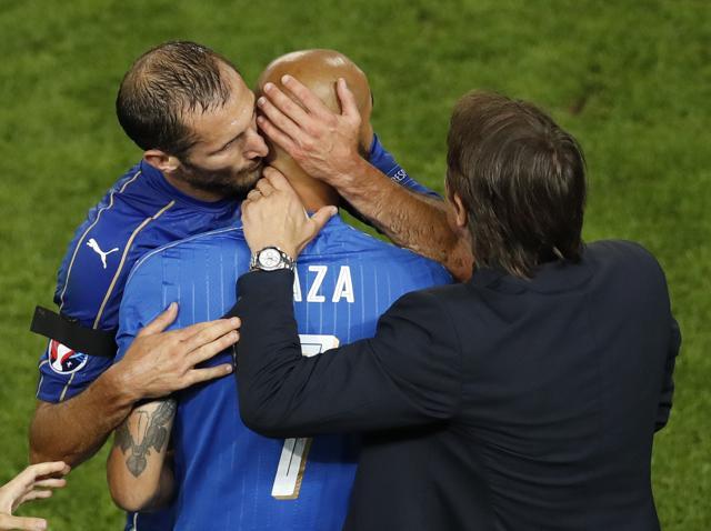 Italy's Giorgio Chiellini (left) kisses his teammate Simone Zaza as he leaves the pitch while coach Antonio Conte looks during the Euro 2016 quarterfinal football match against Germany. (AP Photo) Italy's Giorgio Chiellini (left) kisses his teammate Simone Zaza as he leaves the pitch while coach Antonio Conte looks during the Euro 2016 quarterfinal football match against Germany. (AP Photo)