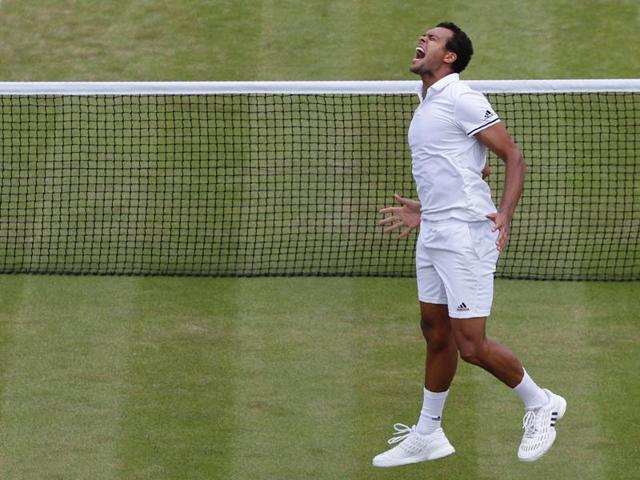 France's Jo-Wilfried Tsonga celebrates defeating US player John Isner in their men's singles third-round at the Wimbledon Championships on July 3, 2016. Tsonga won 6-7 (3), 3-6, 7-6 (5), 6-2, 19-17 in four hours, 25 minutes. (AFP)