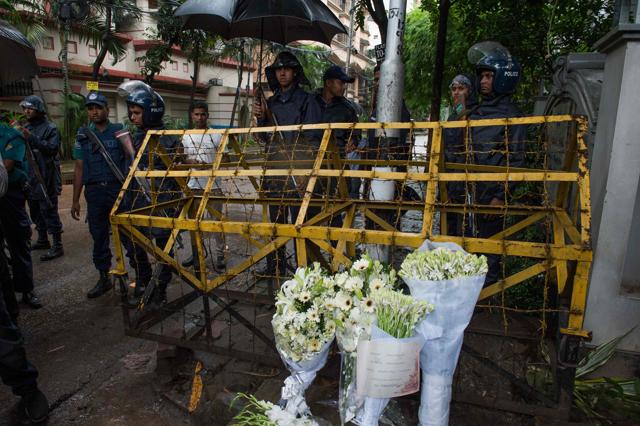 Bangladeshi policemen guard a check point where floral arrangements were left by wellwishers. (AFP) Bangladeshi policemen guard a check point where floral arrangements were left by wellwishers. (AFP)