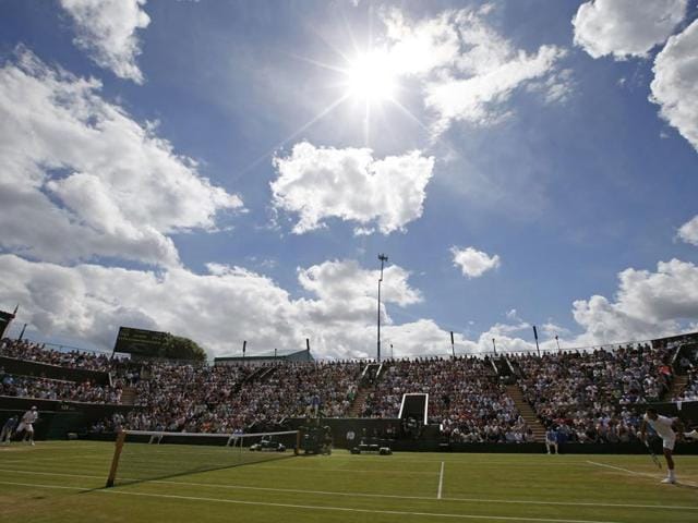 Jo-Wilfried Tsonga in action against John Isner. Wimbledon saw action on the Middle Sunday for just the fourth time ever, thanks to a rain-delayed schedule. (REUTERS)