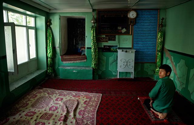 An Afghan adult prays at a shrine ahead of Eid al-Fitr holiday to mark the end of the holy fasting month of Ramadan, in Kabul, Afghanistan, Sunday, July 3, 2016. (AP) 