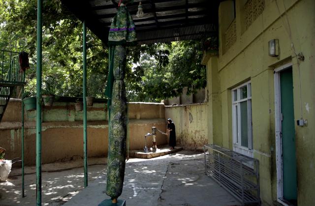 An Afghan woman pumps water at a shrine ahead of Eid al-Fitr holiday to mark the end of the holy fasting month of Ramadan, in Kabul, Afghanistan, Sunday, July 3, 2016. (AP) 