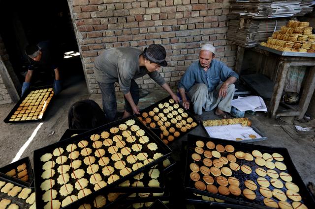 Afghan vendors prepare sweets at a traditional bakery for the upcoming Eid al-Fitr holiday to mark the end of the holy fasting month of Ramadan, in the old part of Kabul, Afghanistan, Sunday, July 3, 2016. (AP) 