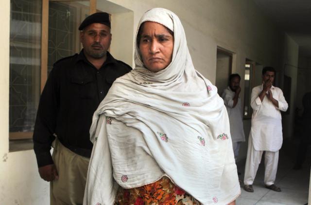 In this file photo, Amina Bibi, centre, who who local police say killed Muqadas Tofeeq, her 22-year-old pregnant daughter, is detained at a police station in Gujranwala, Pakistan. (AP Photo) In this file photo, Amina Bibi, centre, who who local police say killed Muqadas Tofeeq, her 22-year-old pregnant daughter, is detained at a police station in Gujranwala, Pakistan. (AP Photo)