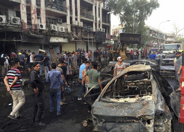 People gather at the site of a suicide car bomb in the Karrada shopping area in Baghdad. (REUTERS) People gather at the site of a suicide car bomb in the Karrada shopping area in Baghdad. (REUTERS)