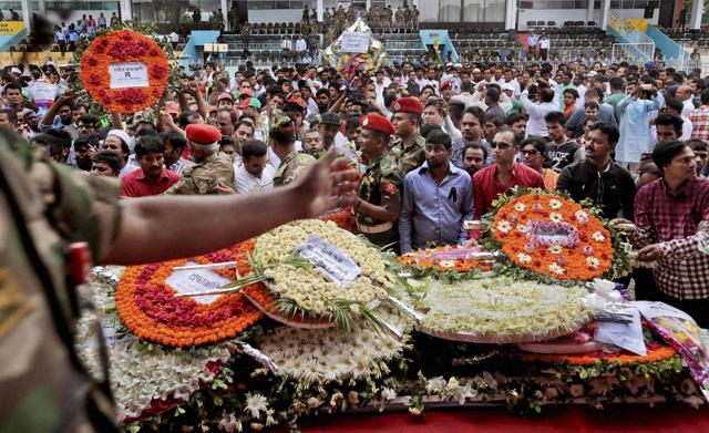 A Bangladeshi soldier controls local residents as they pour in to pay their respects to the victims of the attack on Holey Artisan Bakery, at a stadium in Dhaka. (AP) A Bangladeshi soldier controls local residents as they pour in to pay their respects to the victims of the attack on Holey Artisan Bakery, at a stadium in Dhaka. (AP)