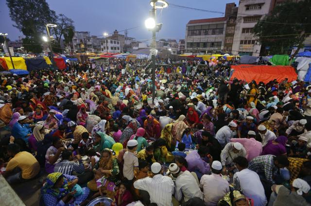 Muslims who arrived in the city for shopping on the last Sunday ahead of Eid al-Fitr, break their day long fast at a special Iftar hosted for them by traders at a market in Ahmadabad, India, Sunday, July 3, 2016.  (AP) 