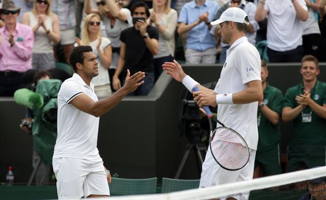 Isner, the winner of the longest tennis match ever, shakes hands with Tsonga at the net after the match. (AP)