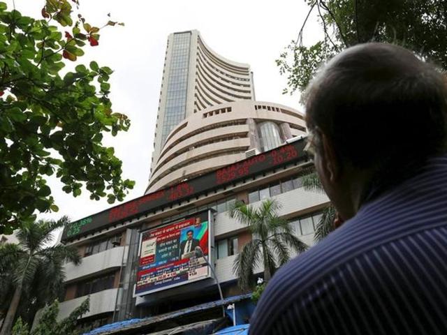 A man looks at a screen across a road displaying the Sensex on the facade of the Bombay Stock Exchange (BSE) building in Mumbai.(HT Archive) A man looks at a screen across a road displaying the Sensex on the facade of the Bombay Stock Exchange (BSE) building in Mumbai.(HT Archive)