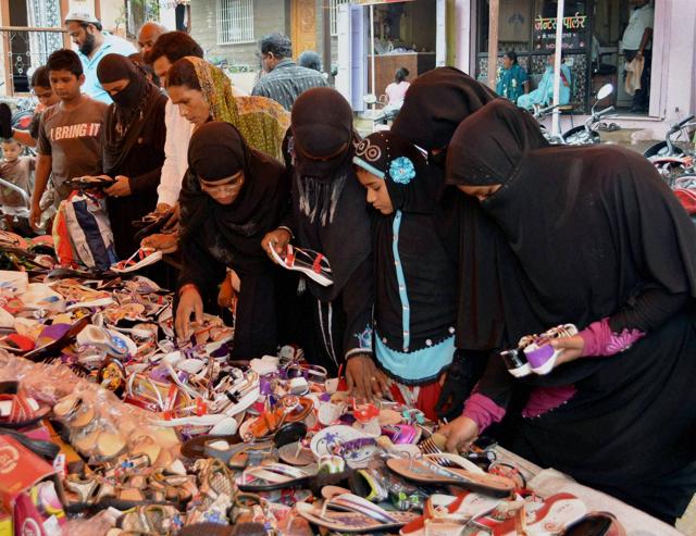 Muslim women shop in a market ahead of the Eid-ul-Fitr festival in Karad, Maharashtra on Sunday.  (PTI) 