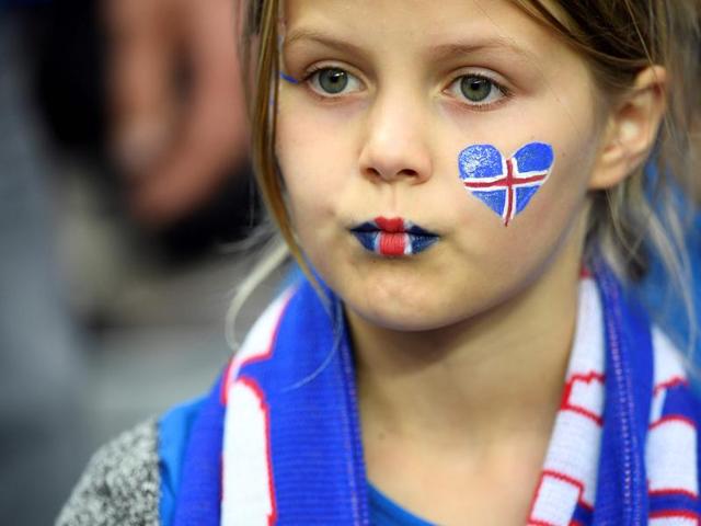 A young Iceland supporter looks on at the start of the Euro 2016 quarter-final football match between France and Iceland. (AFP photo) 