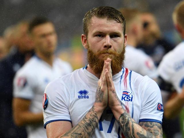 Iceland's midfielder Aron Gunnarsson reacts after the Euro 2016 quarter-final  loss with the universal sign of  seeking forgiveness  and  showing gratitude. (AFP photo) 