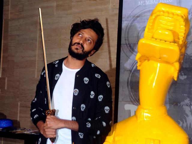 Riteish Deshmukh apes the statue at party for a newly-opened restaurant in Mumbai. (AFP) 