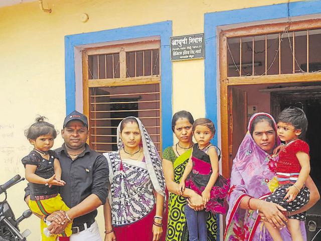 Anil Yadav (left) outside a house where he installed a name plate in Betul. (HT photo) Anil Yadav (left) outside a house where he installed a name plate in Betul. (HT photo)