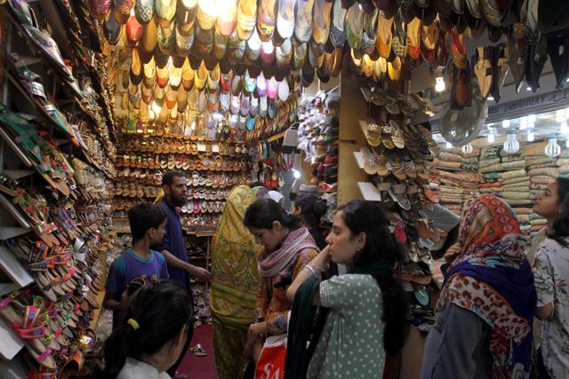 Pakistani women buy shoes for the upcoming Eid al-Fitr holiday to mark the end of the holy fasting month of Ramadan in Karachi, Pakistan, Sunday, July 3, 2016.  (AP) 