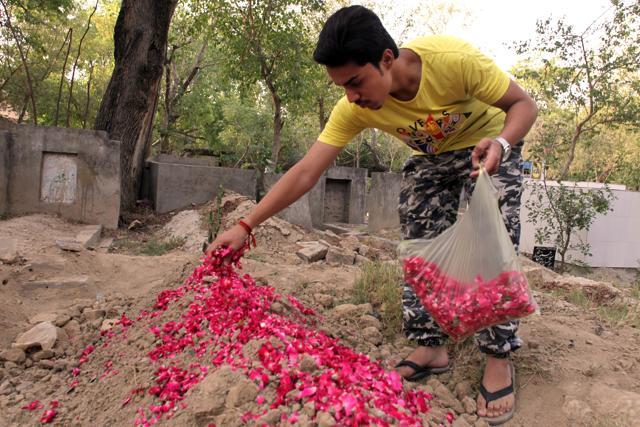 Hassan Khan, whose wife Zeenat was killed by her mother, lays rose petals on her grave in Lahore, Pakistan. (AP Photo) Hassan Khan, whose wife Zeenat was killed by her mother, lays rose petals on her grave in Lahore, Pakistan. (AP Photo)
