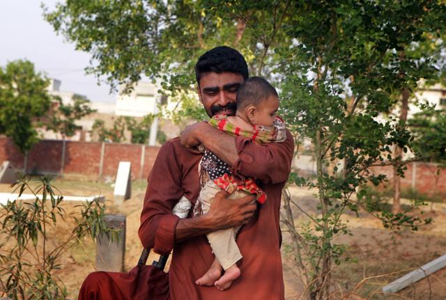 In this June 18 photo, Mohammed Tofeeq cries as he holds his 10-month-old daughter, Gulshan Tofeeq, at the grave of his wife Muqadas Tofeeq, who local police say was killed by her mother, in Butrawala village on the outskirts of Gujranwala, Pakistan. (AP) In this June 18 photo, Mohammed Tofeeq cries as he holds his 10-month-old daughter, Gulshan Tofeeq, at the grave of his wife Muqadas Tofeeq, who local police say was killed by her mother, in Butrawala village on the outskirts of Gujranwala, Pakistan. (AP)